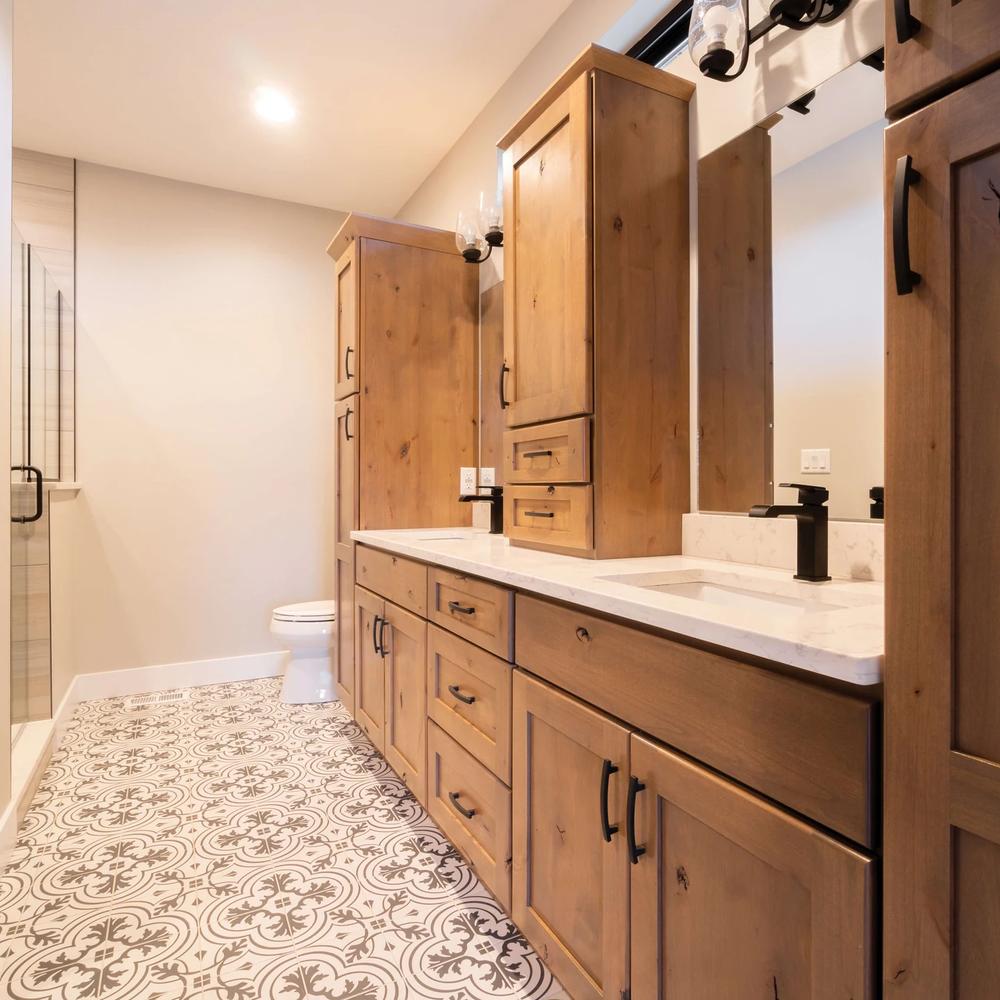 Light Wood and Marble Fusion Vanity highlighting a seamless countertop and modern faucets.