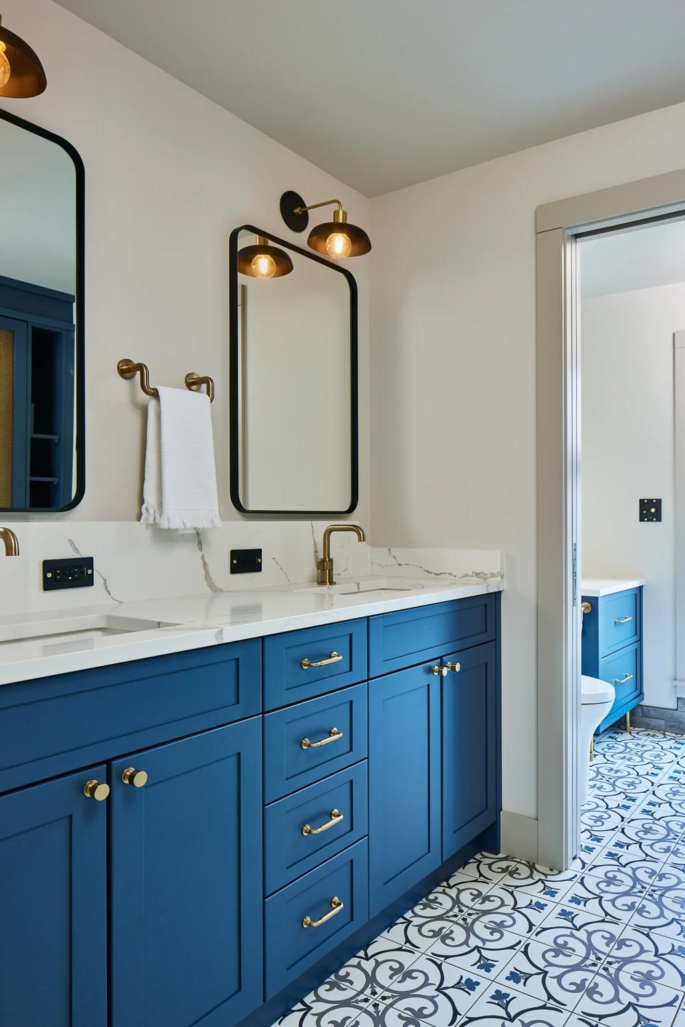 Striking Blue Vanity with Gold Accents showcasing dual sinks and unique decor.