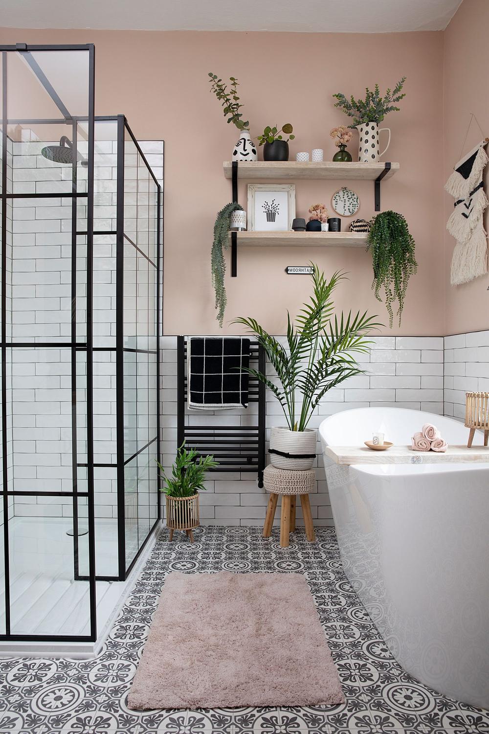 A modern bathroom defined by unique geometric patterns, an elegant freestanding bathtub, and stylish accessories that complement the design scheme.