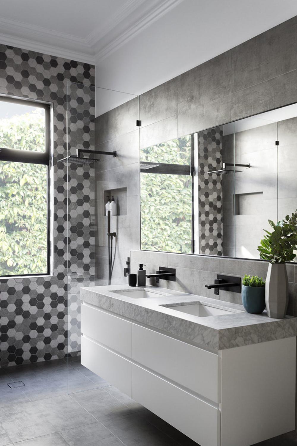 An elevated urban bathroom featuring a stylish vanity, hexagonal tile pattern, and ample lighting that create an inviting contemporary design.