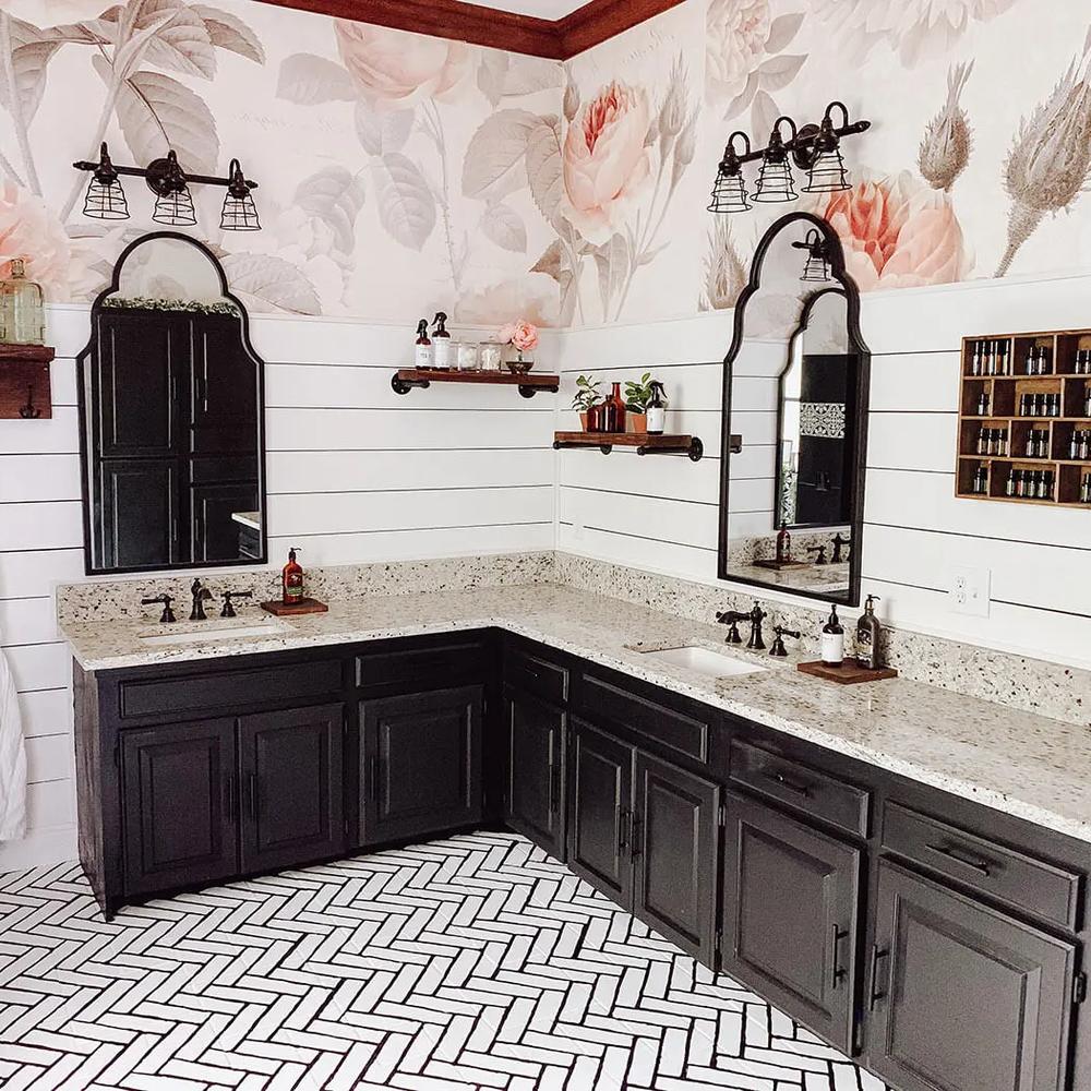 Rustic farmhouse bathroom showcasing sophisticated deep colors with black cabinets.