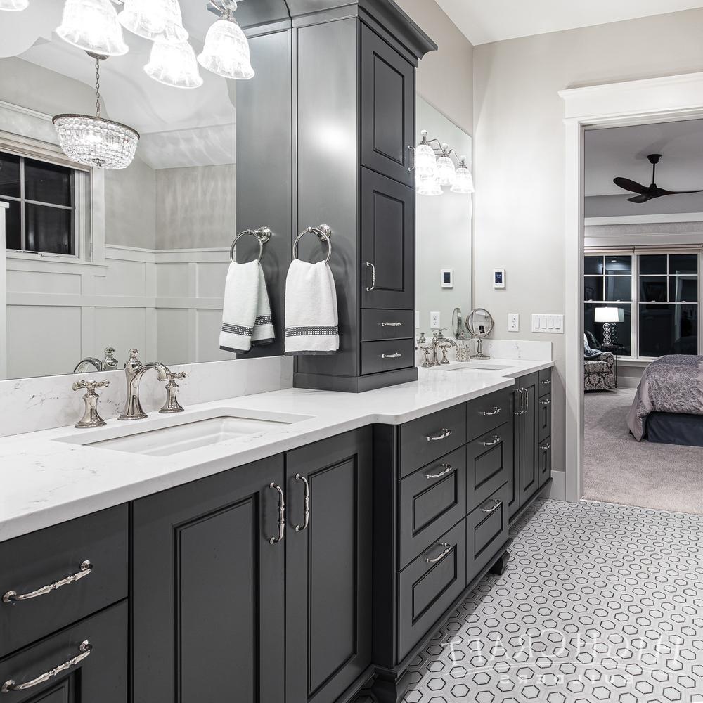 Bright and airy American farmhouse bathroom featuring natural light and black cabinetry.