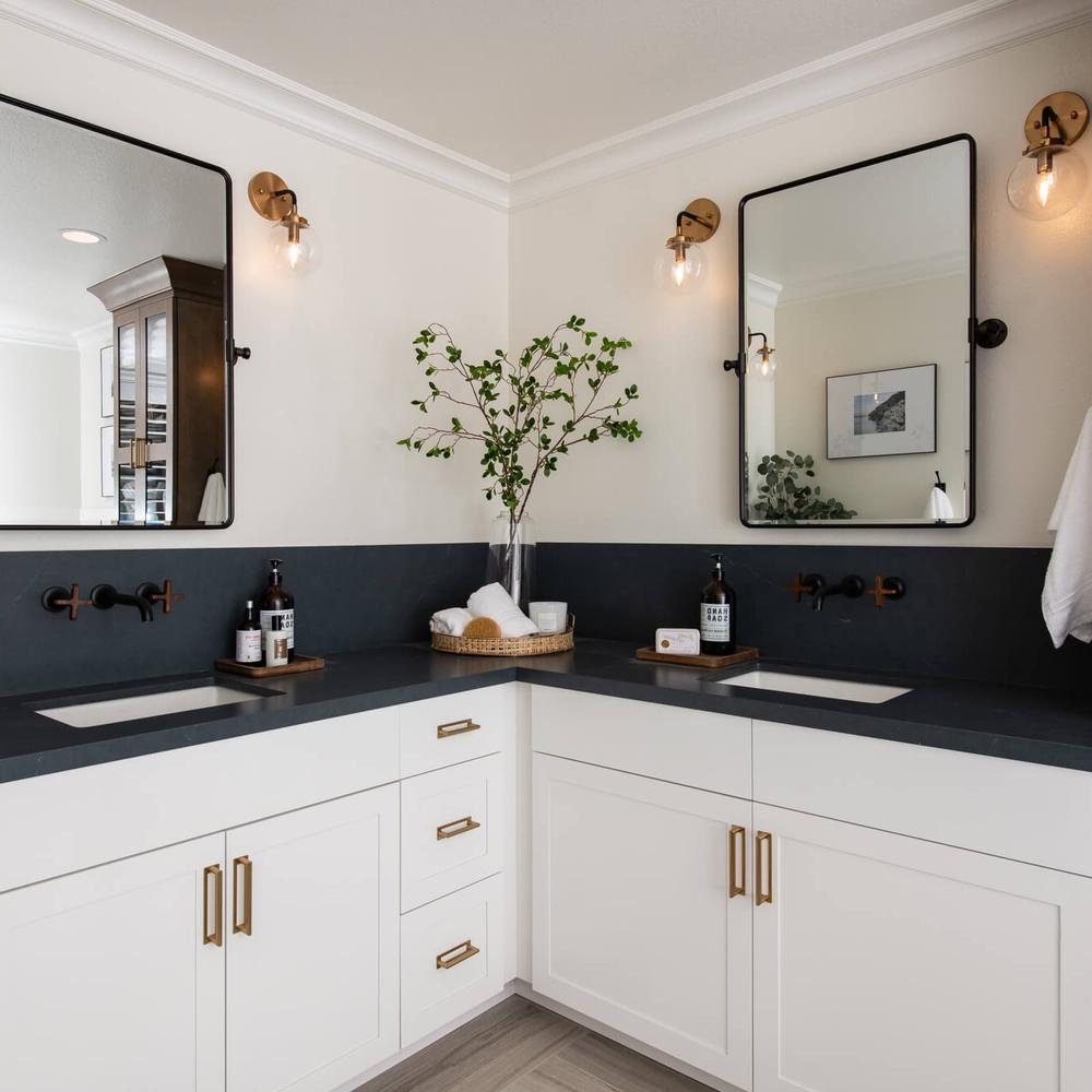 American farmhouse bathroom designed for an invigorating cleansing experience featuring elegant black cabinetry.