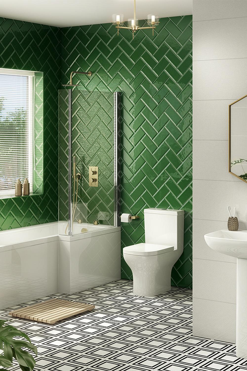 Stylish Art Deco bathroom with glossy green herringbone tiles and sleek fixtures