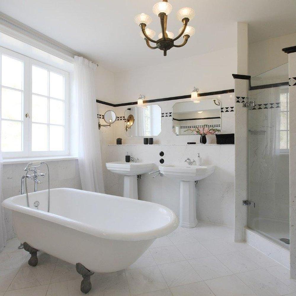 Neutral-toned Art Deco bathroom featuring freestanding bathtub