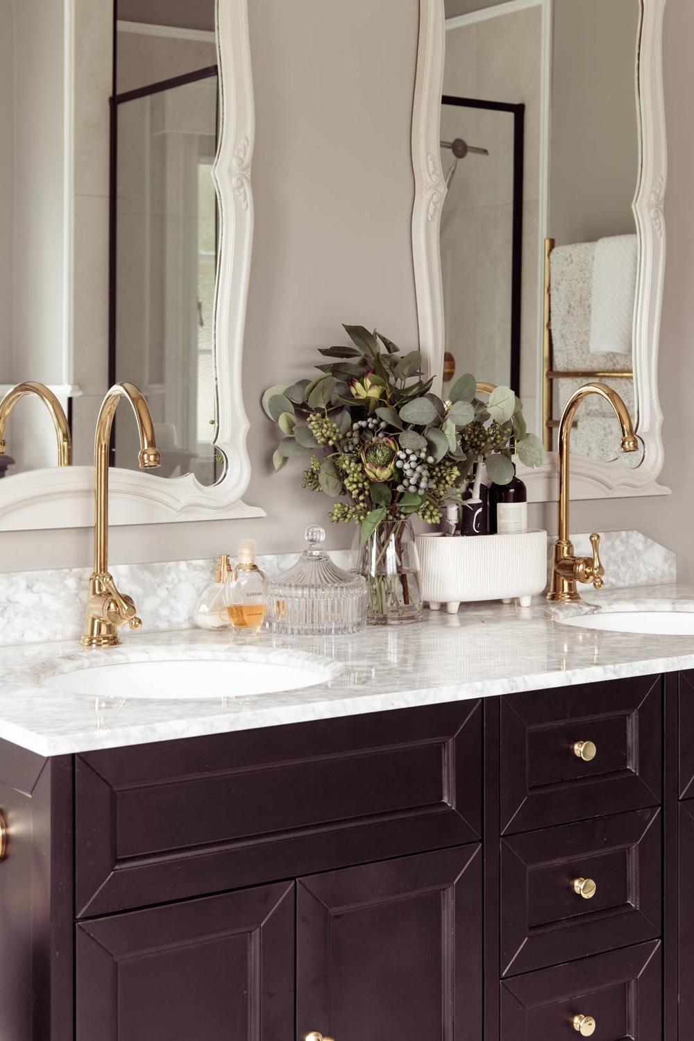 Art Deco bathroom filled with deep teal and warm accents