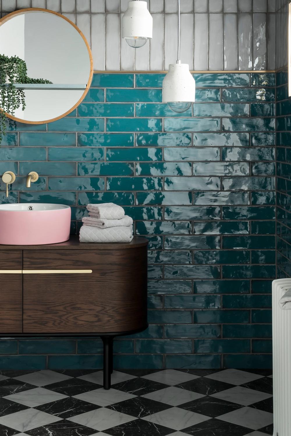 Vibrant Art Deco bathroom featuring glossy turquoise tiles and a unique vanity.