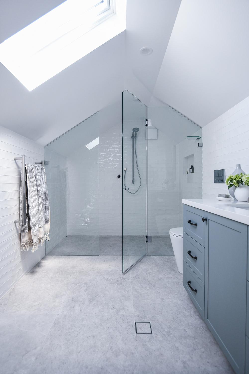 Streamlined modern attic bathroom with natural lighting