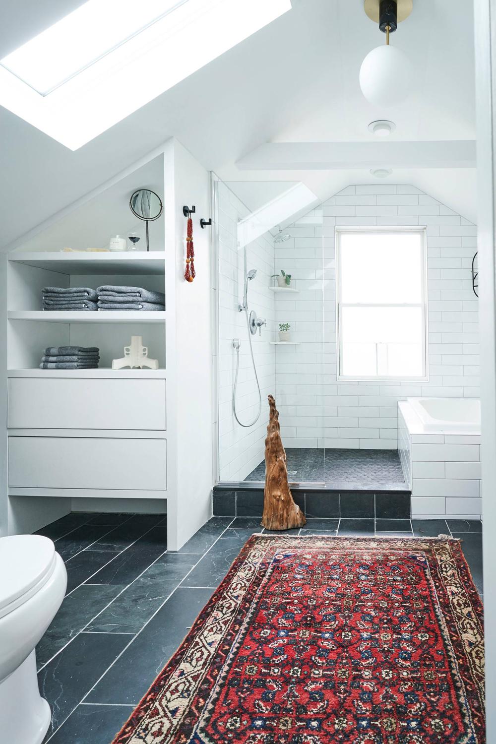 Luxury attic bathroom with freestanding tub and elegant fixtures