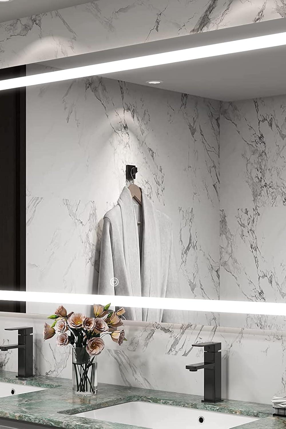 Modern dual sink setup with backlit mirrors enhancing a stylish bathroom design