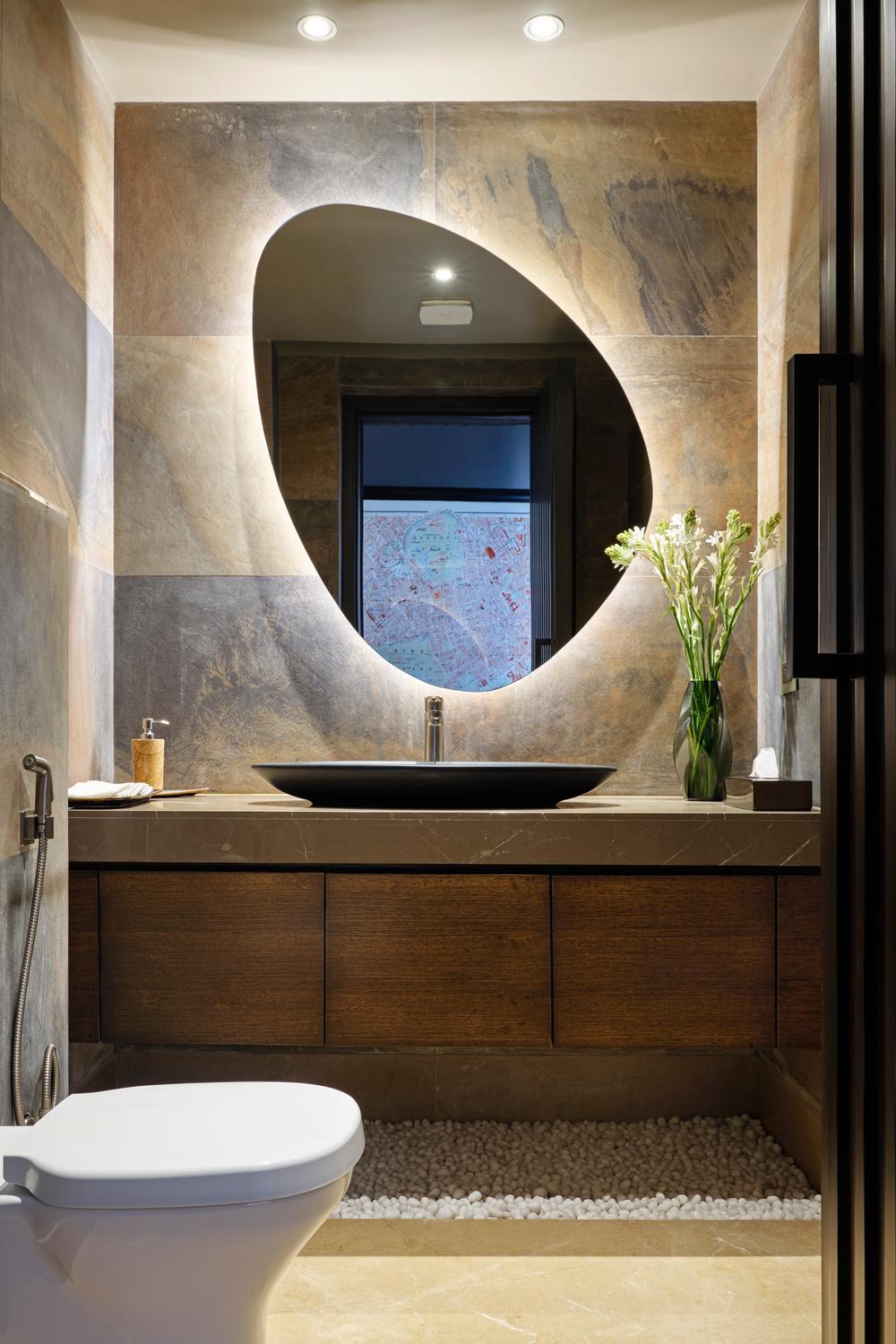 Modern sink design supported by a backlit mirror and organized accessories in the bathroom