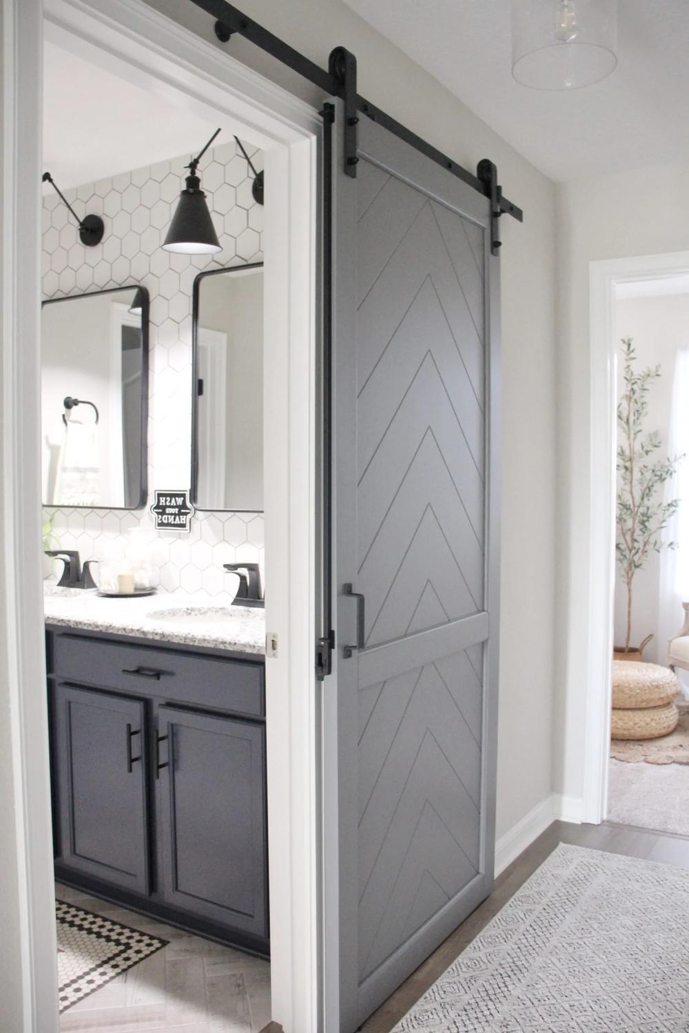Entrada a un baño moderno con puerta de granero y azulejos hexagonales