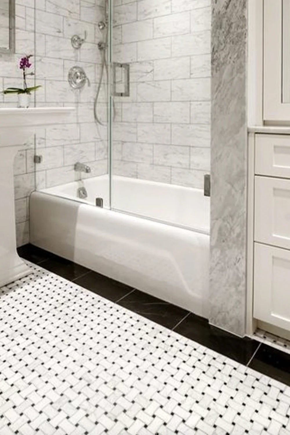 Basketweave tile bathroom showcasing a clean and elegant design with striking black and white tiles.