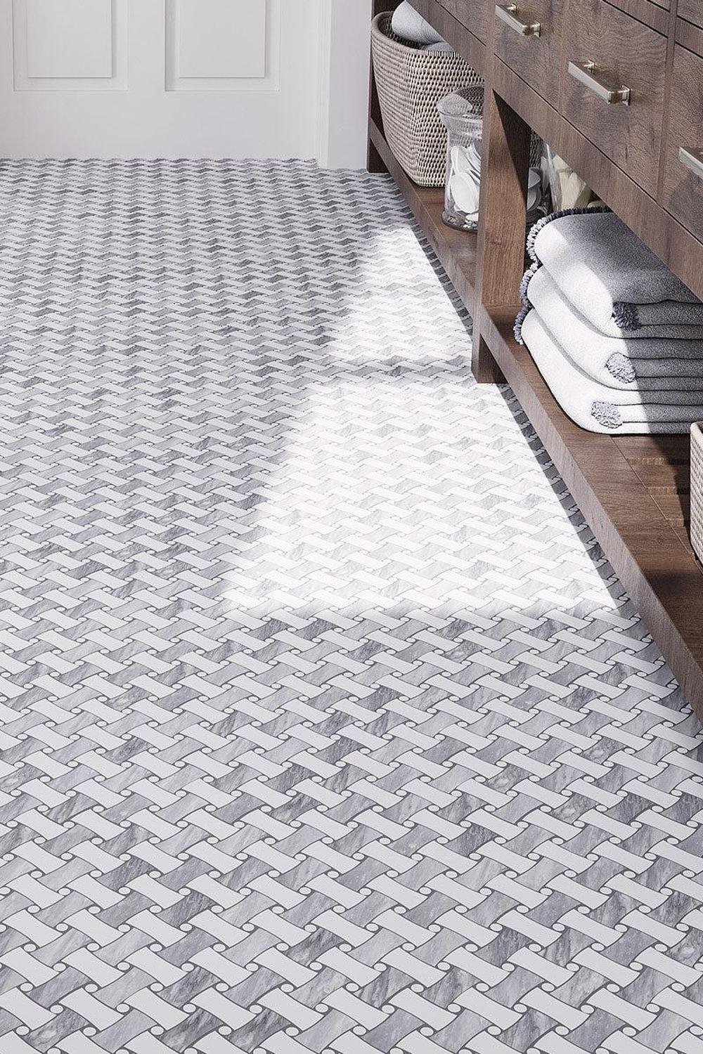 Bathroom with luxurious fixtures and basketweave tile, showcasing a calming design.