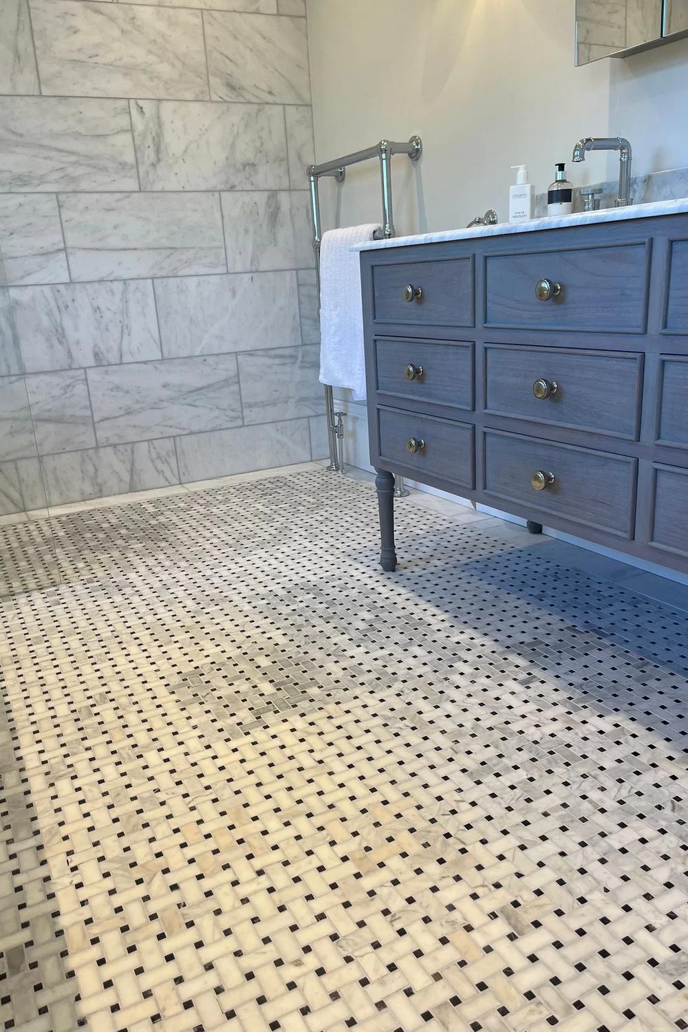 Chic bathroom featuring a sophisticated geometric pattern with basketweave tile.