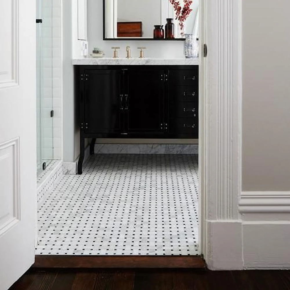 Modern bathroom with a black vanity design enhancing the basketweave tile floor.