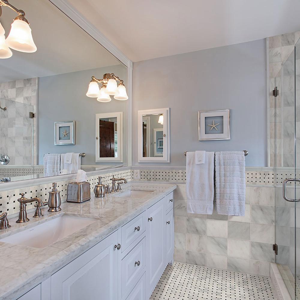 Eclectically styled bathroom mixing materials with basketweave tiles and light marble walls.