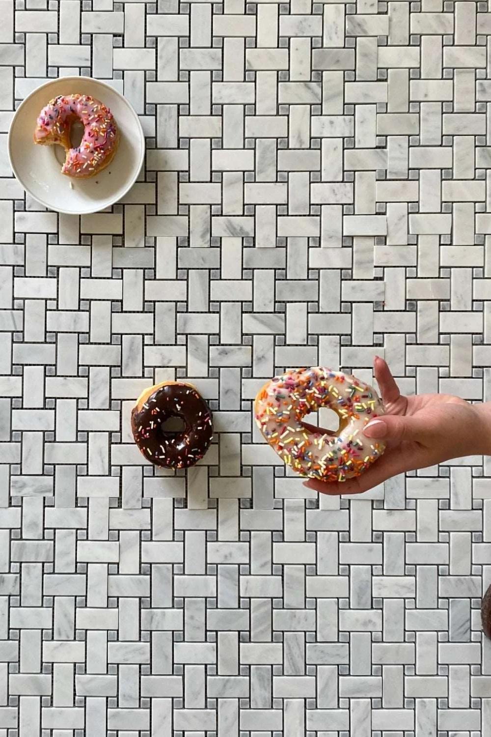 Bathroom with personalized decorative touches alongside basketweave tile floor design.