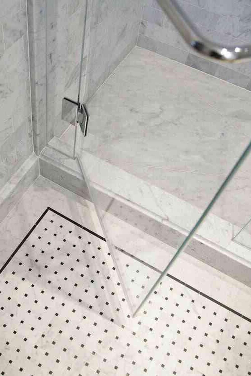 Stylish bathroom with layered lighting enhancing the ambiance around basketweave tile.