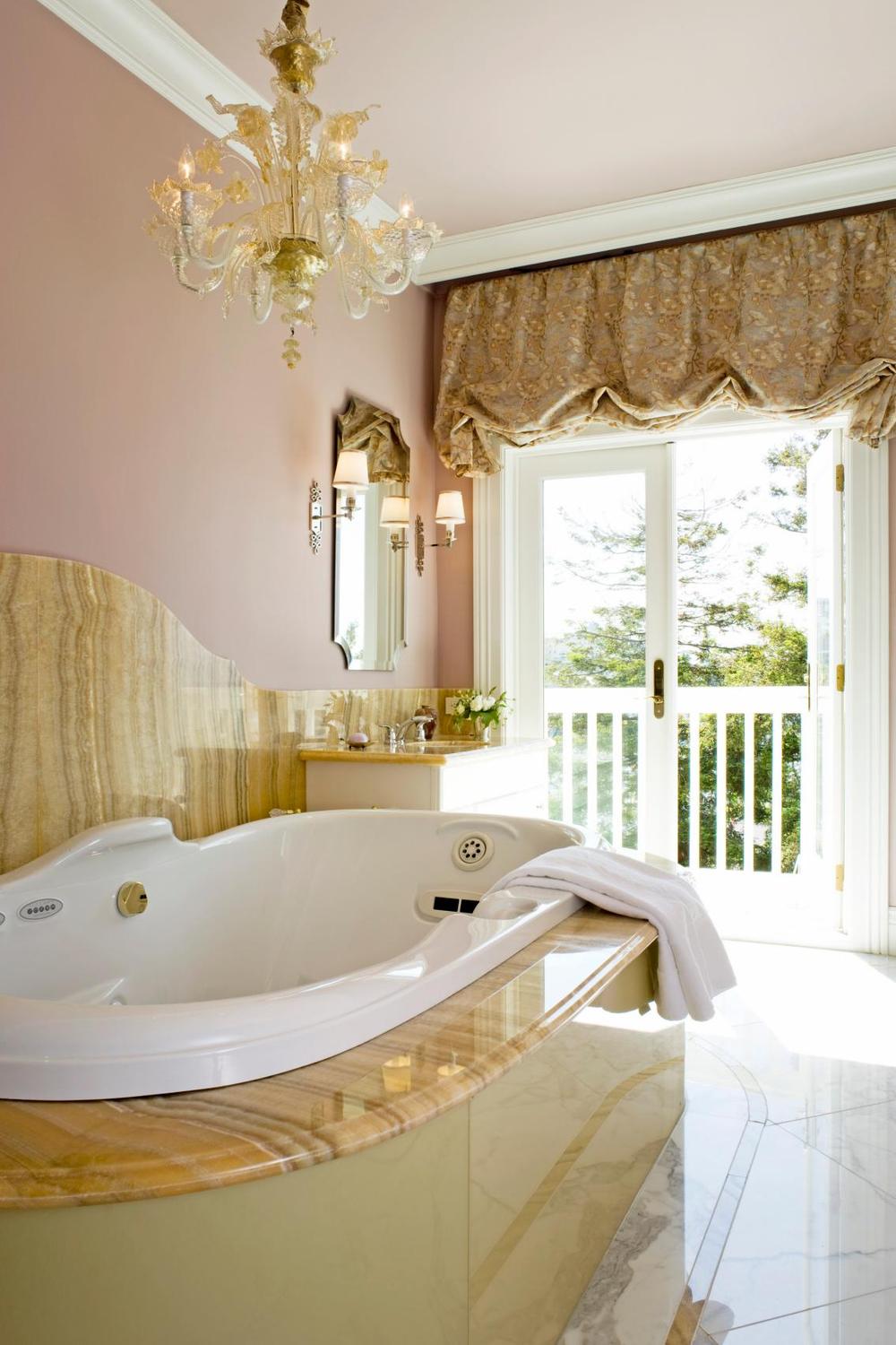 A serene bathroom designed with soft pink tones and decorative elements