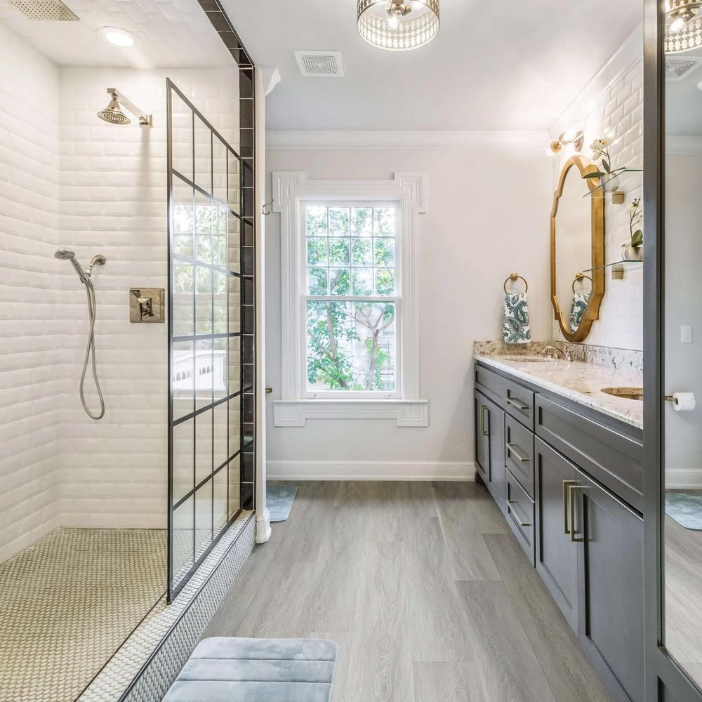 Stylish modern bathroom with warm gray wood-like laminate flooring