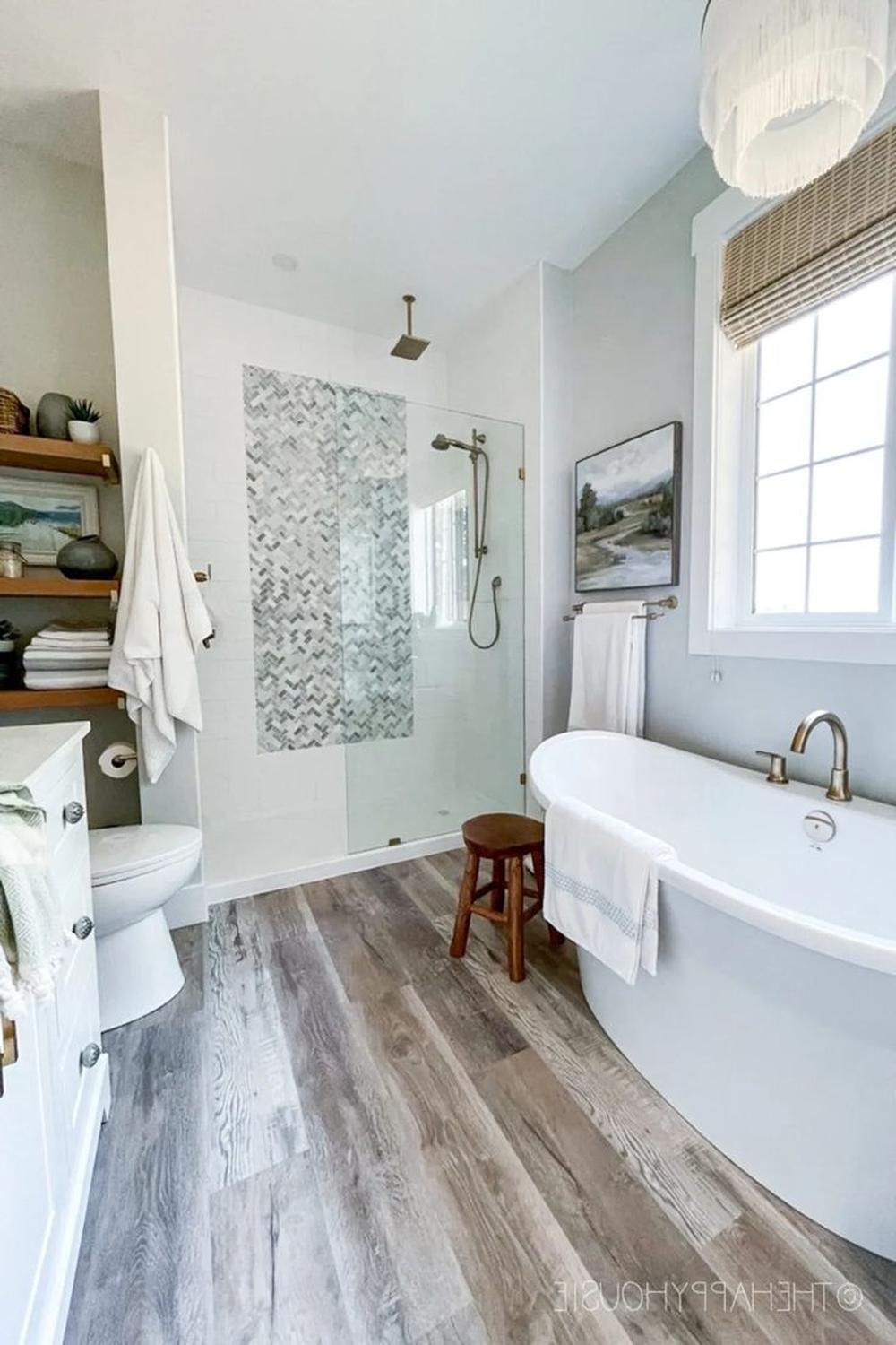 Modern bathroom with wood-like laminate flooring and stylish fixtures
