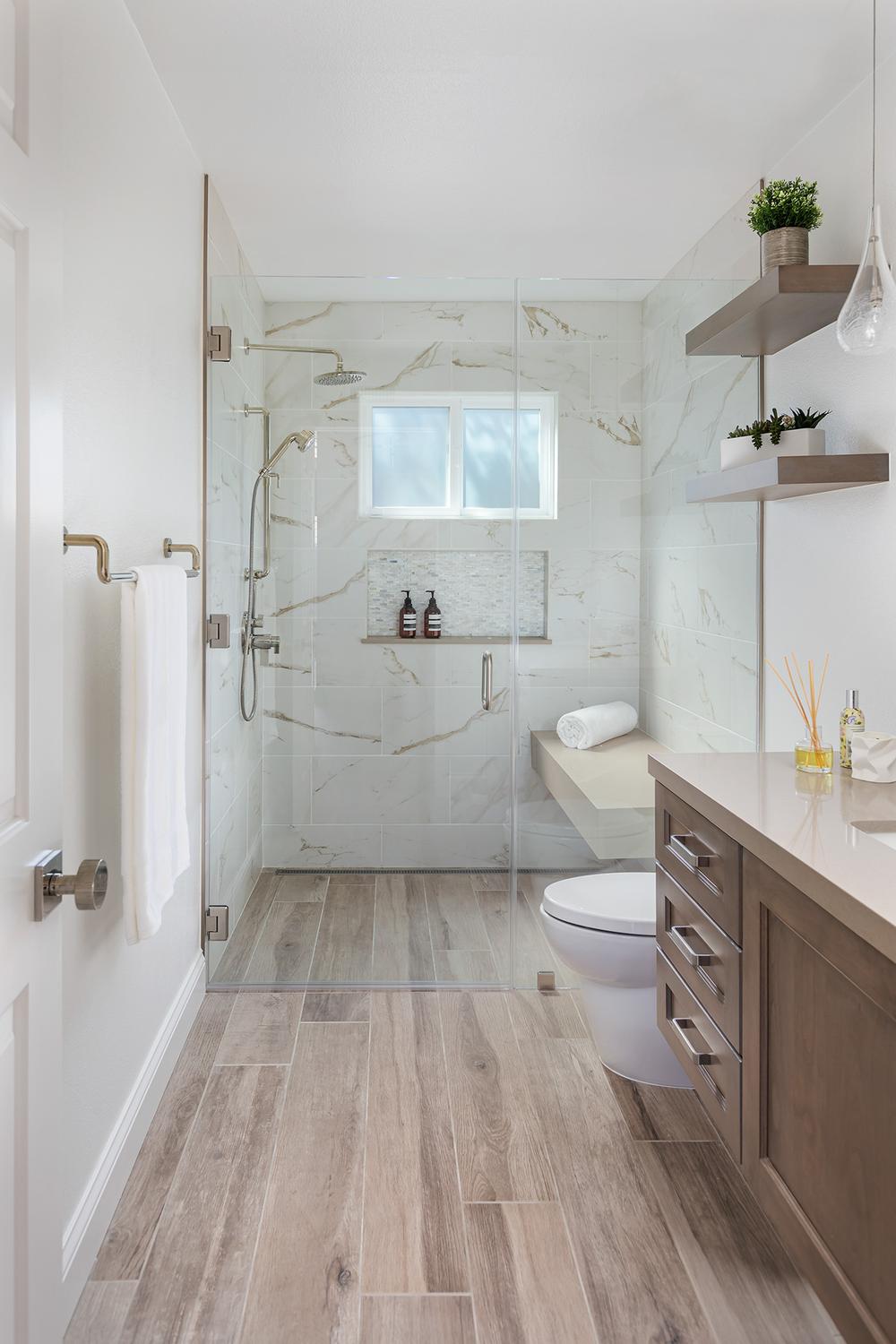 Modern bathroom featuring sleek wood-like tiles with natural accents