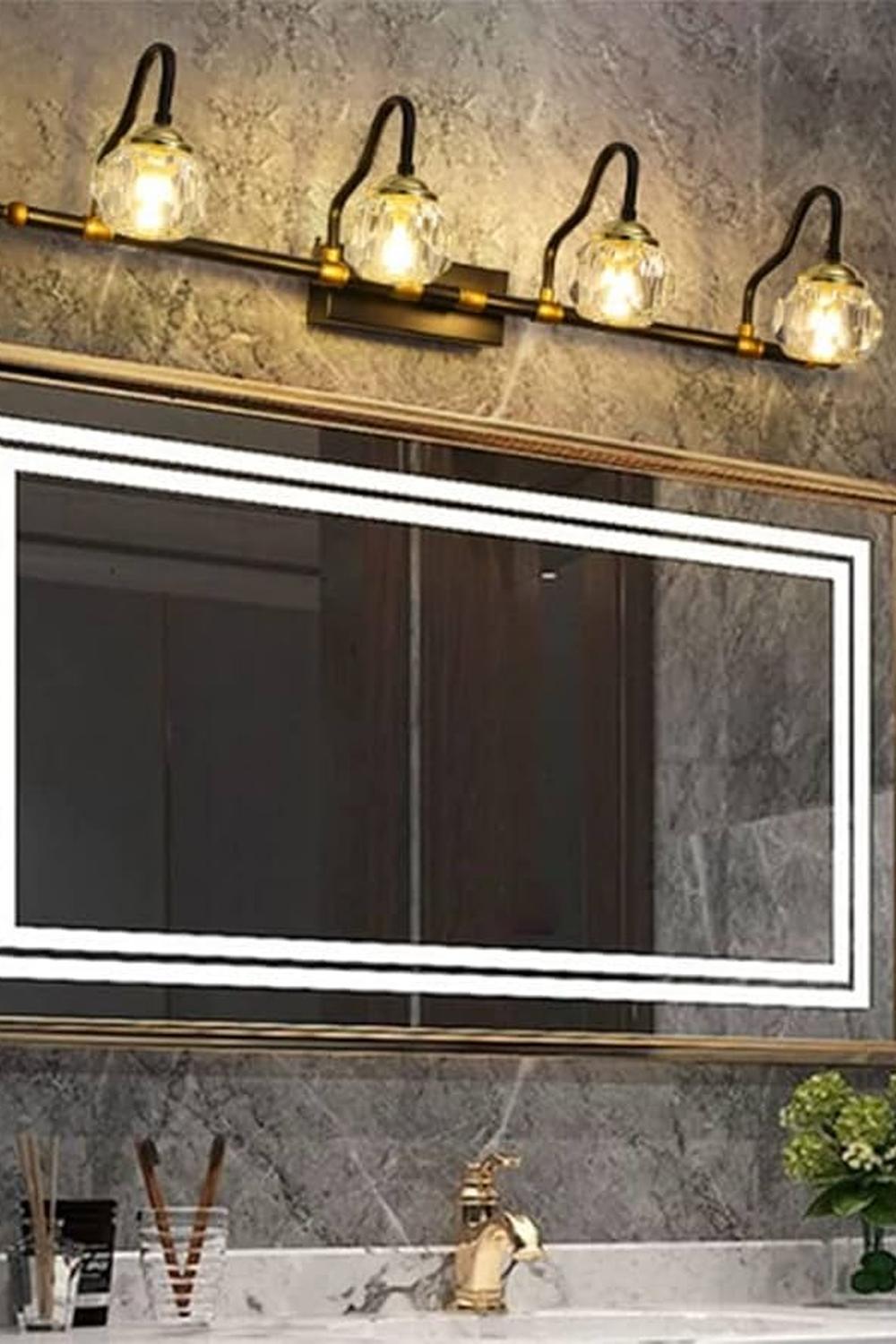 Modern bathroom with a backlit mirror and stylish sconces giving a warm ambiance.