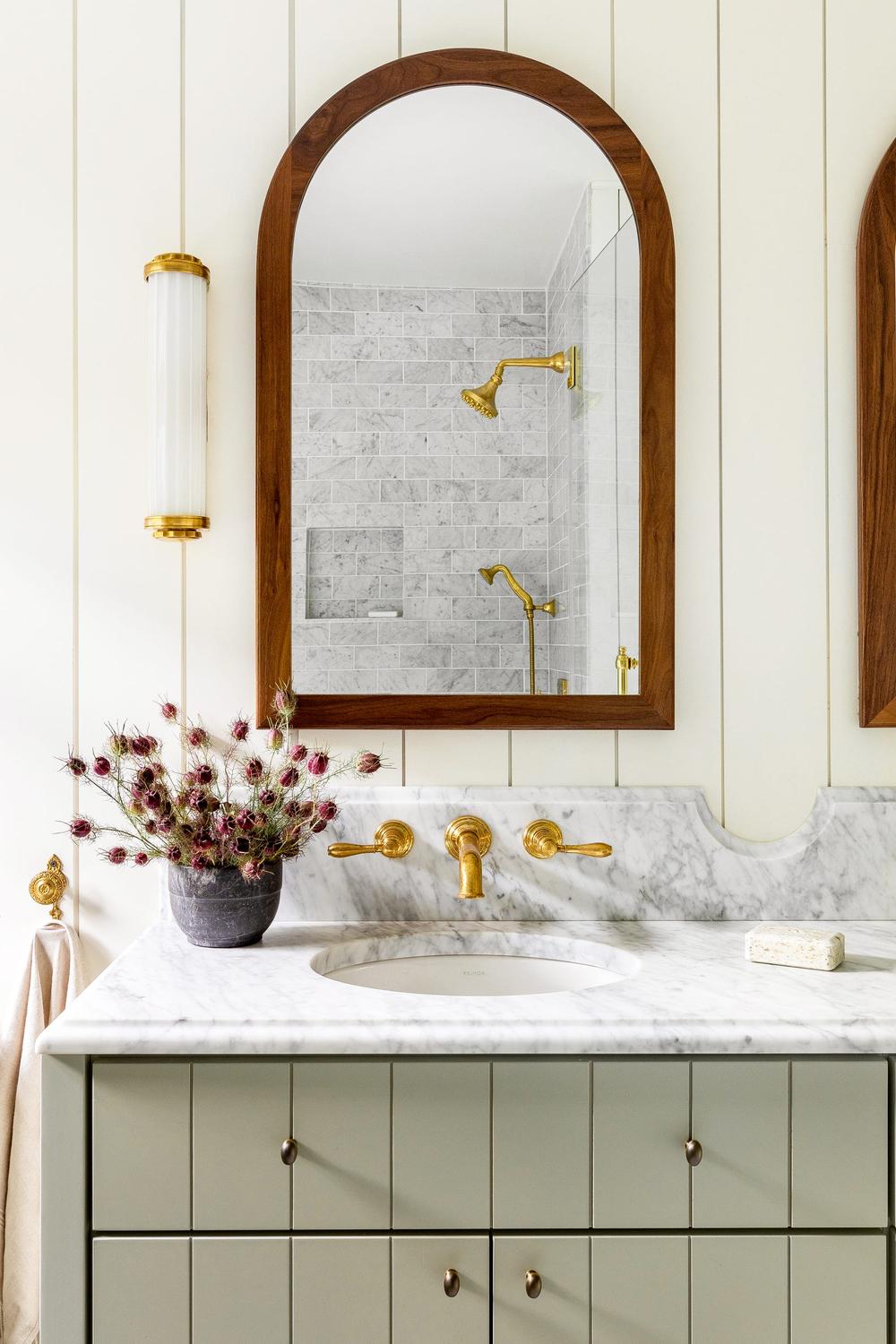 Warm bathroom featuring rounded elements with natural-inspired design.