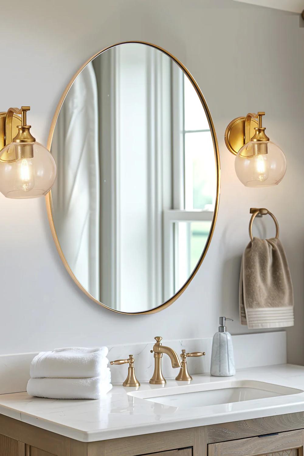 Stylish vintage bathroom featuring elegant mirrors and brass fixtures.