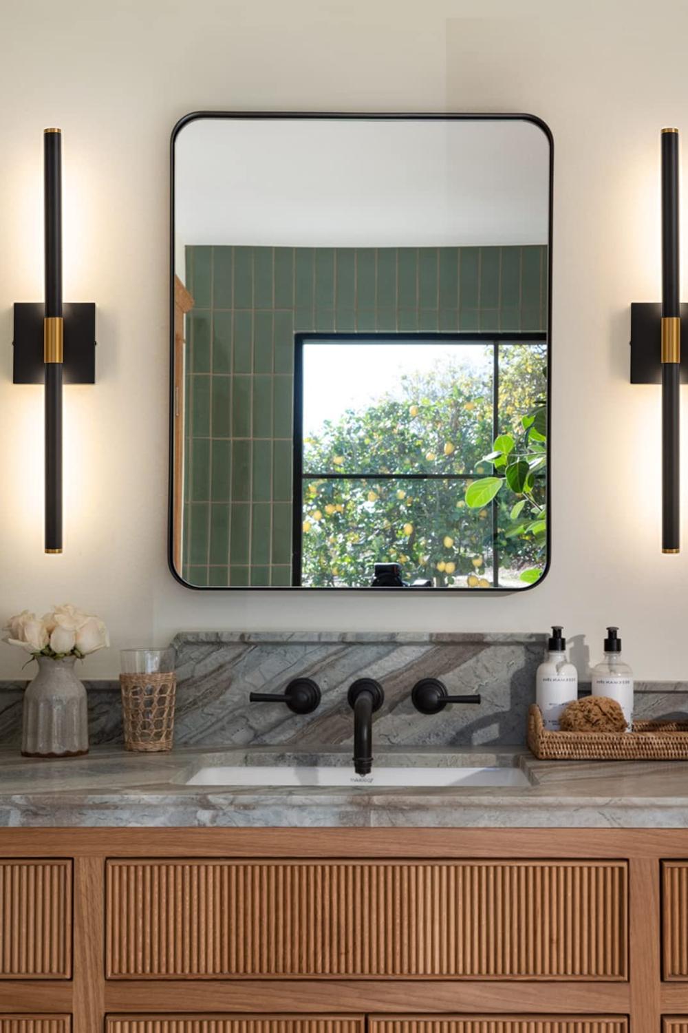 Stylishly modern bathroom with flowing lines and beautifully matched sconces.