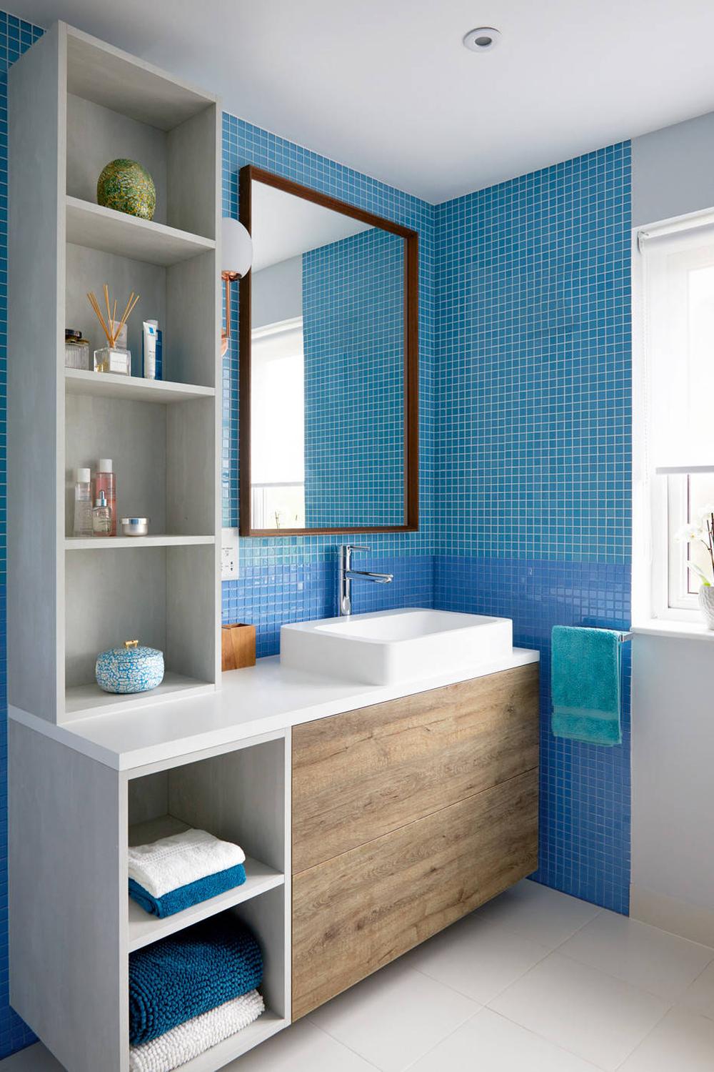 A bathroom featuring vibrant blue mosaic tiles adding a refreshing atmosphere.