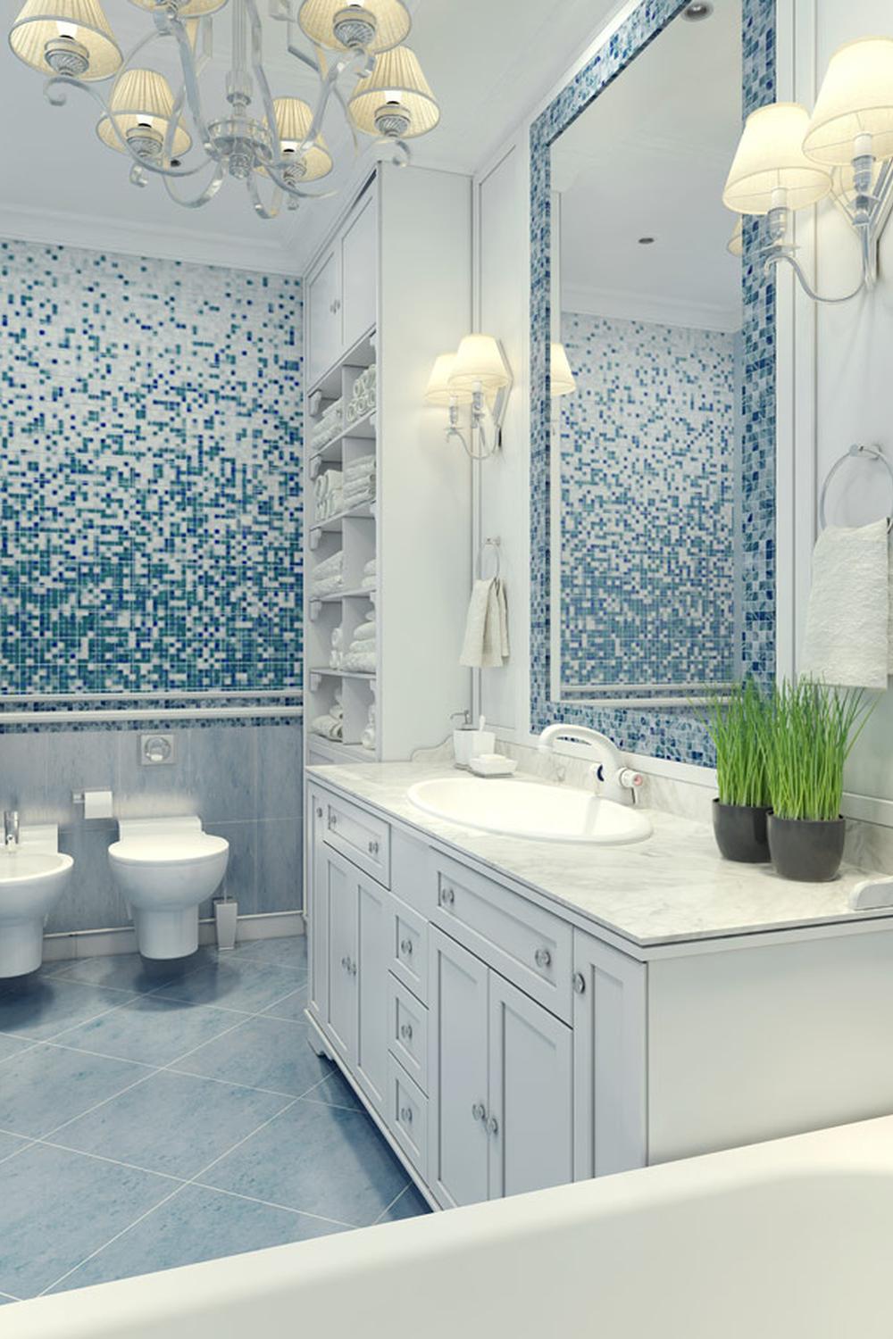 A serene bathroom featuring a gradient of blue mosaic tiles and elegant fixtures.