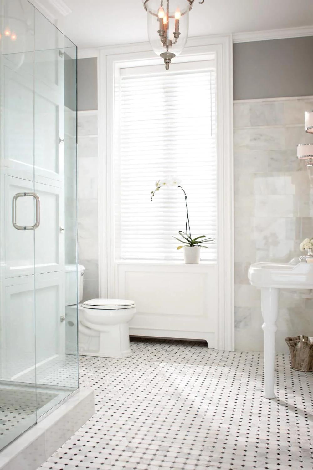 A stylish bathroom featuring black and white penny tile flooring.
