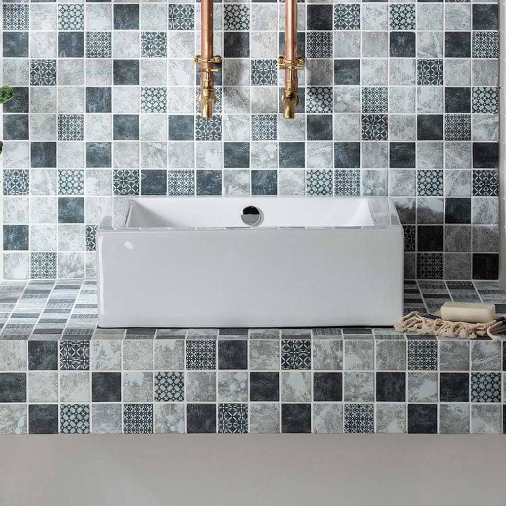 A modern bathroom adorned with striking mosaic tile design in gray, white, and black.