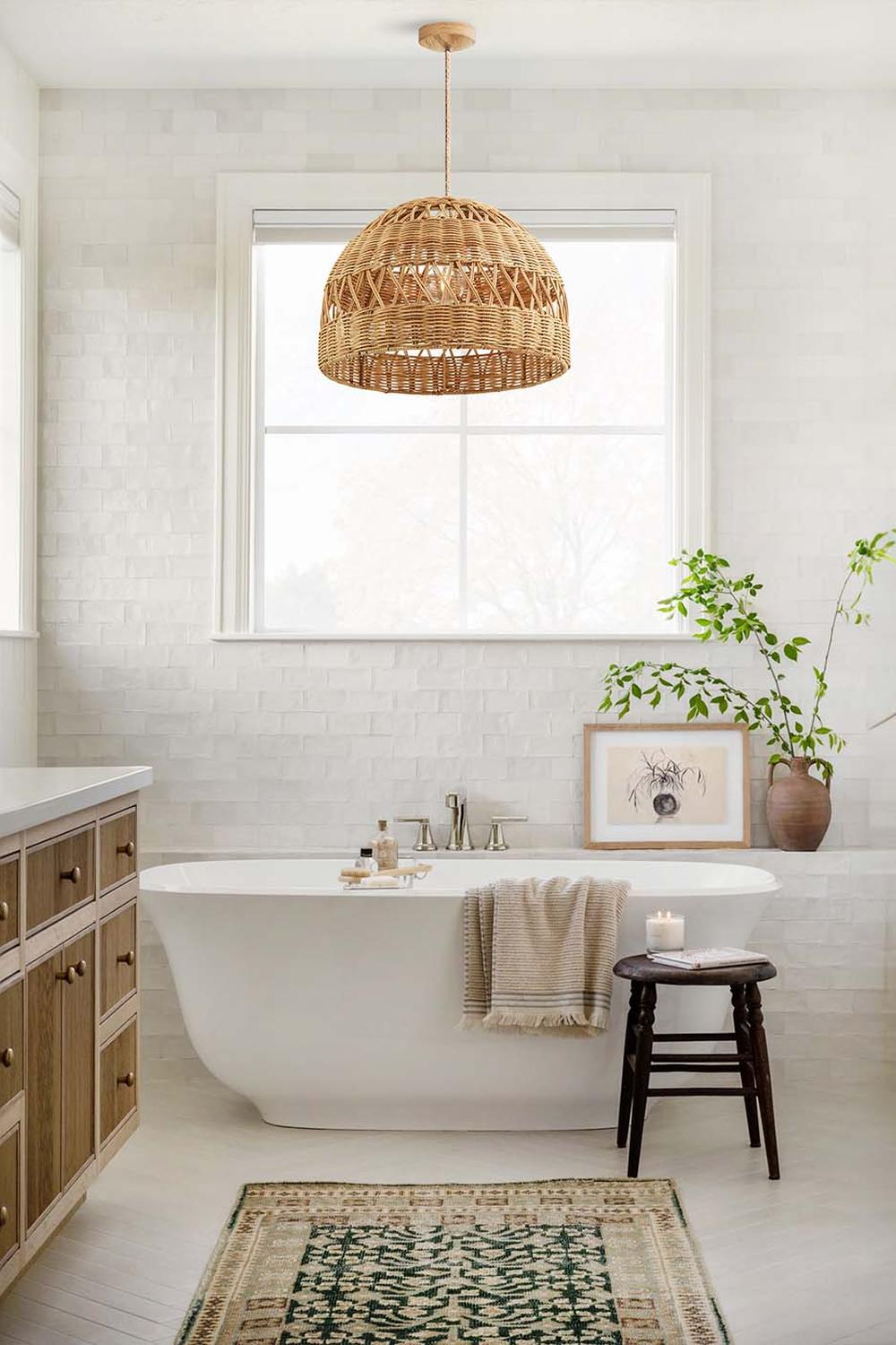 A beautifully designed bathroom featuring a woven pendant light and a freestanding bathtub.