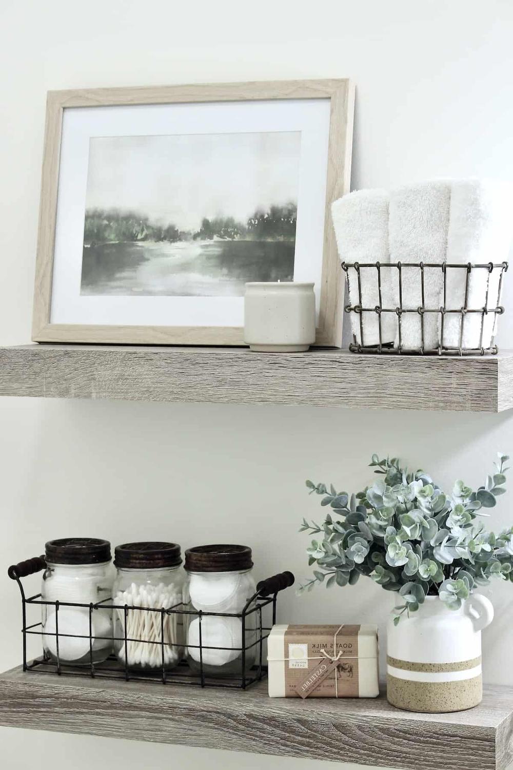 Stylish bathroom shelf decor with watercolor art and candles