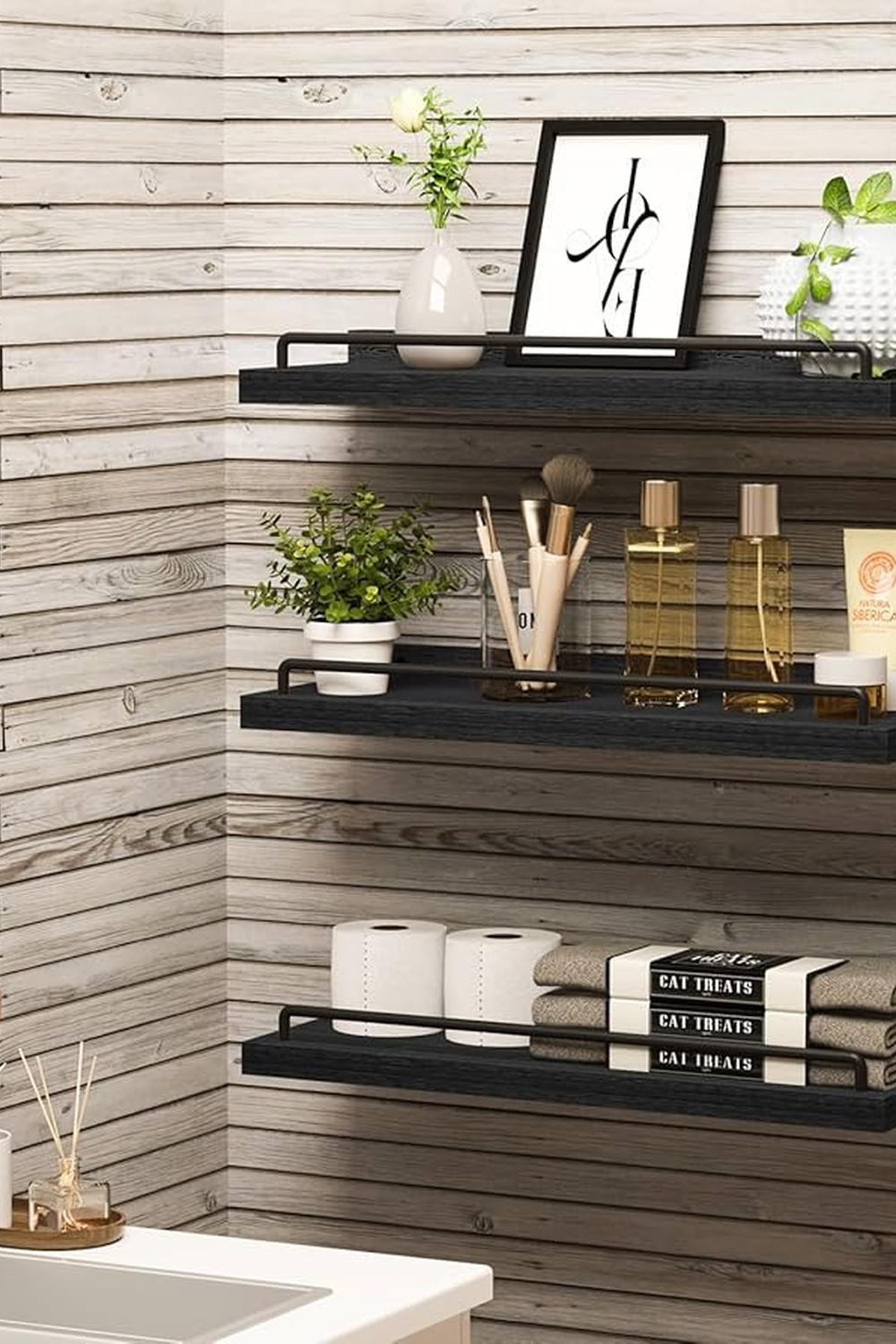 Minimalist bathroom shelf decor with dark wooden shelves