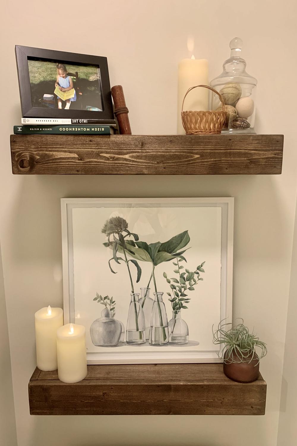 Bathroom shelves displaying family photos and candlelight