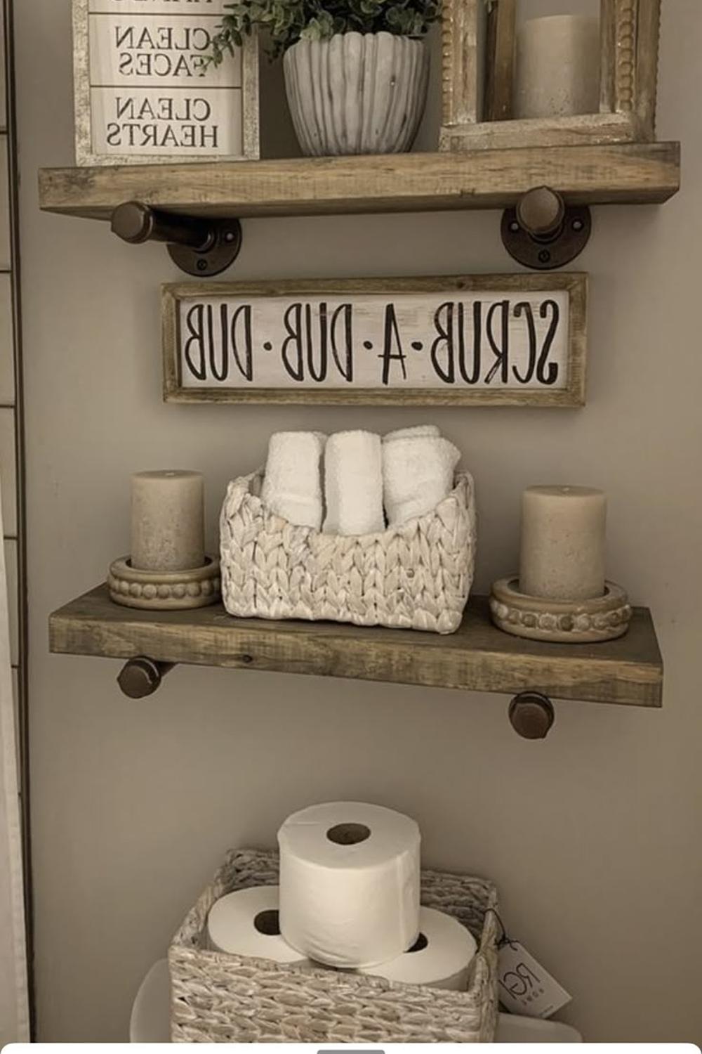 Bathroom shelf decor with playful signs and greenery