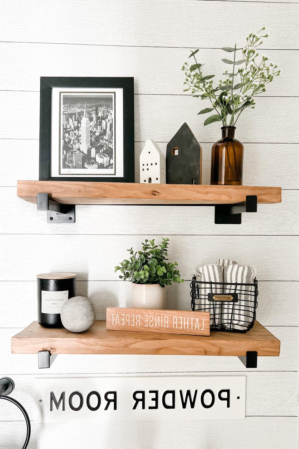 Bathroom shelf decor including black-and-white art