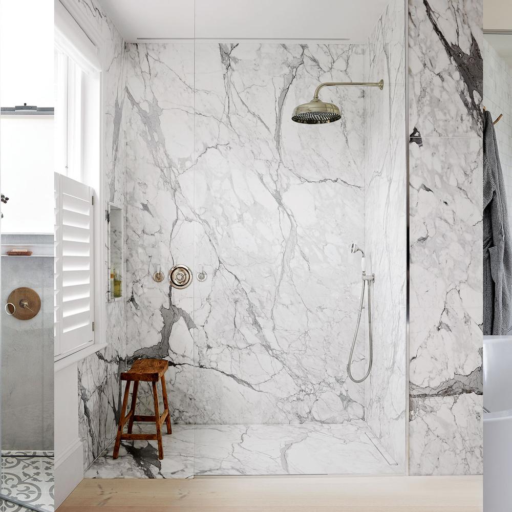 Luxurious marble walls in a modern shower area providing a sophisticated aesthetic