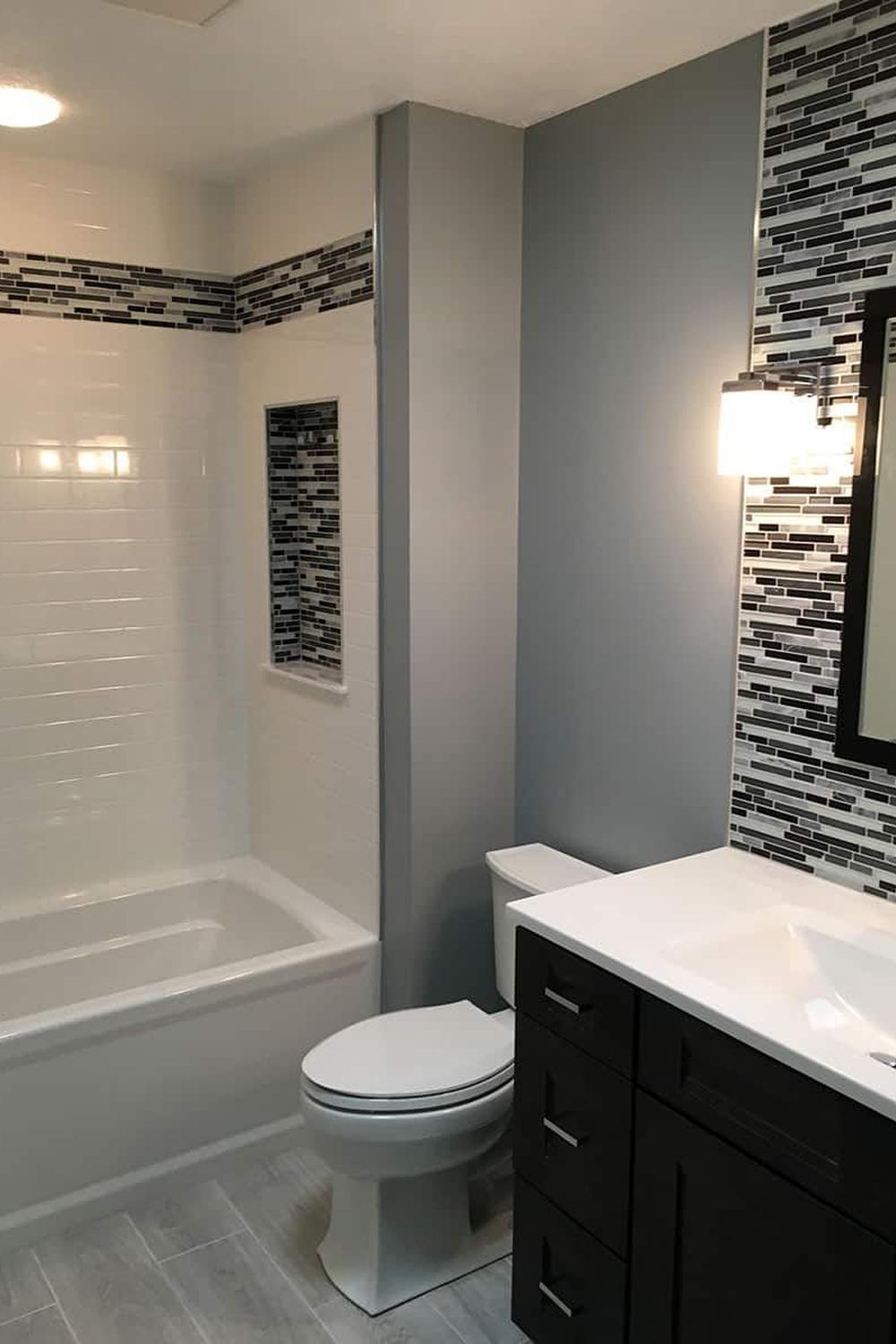 Practical shower design showcasing a practical niche and stylish bathtub