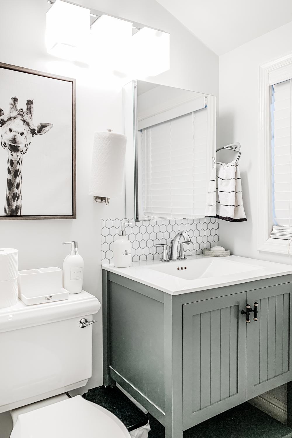 White hexagonal tiles create geometric flair in a stylish modern bathroom.