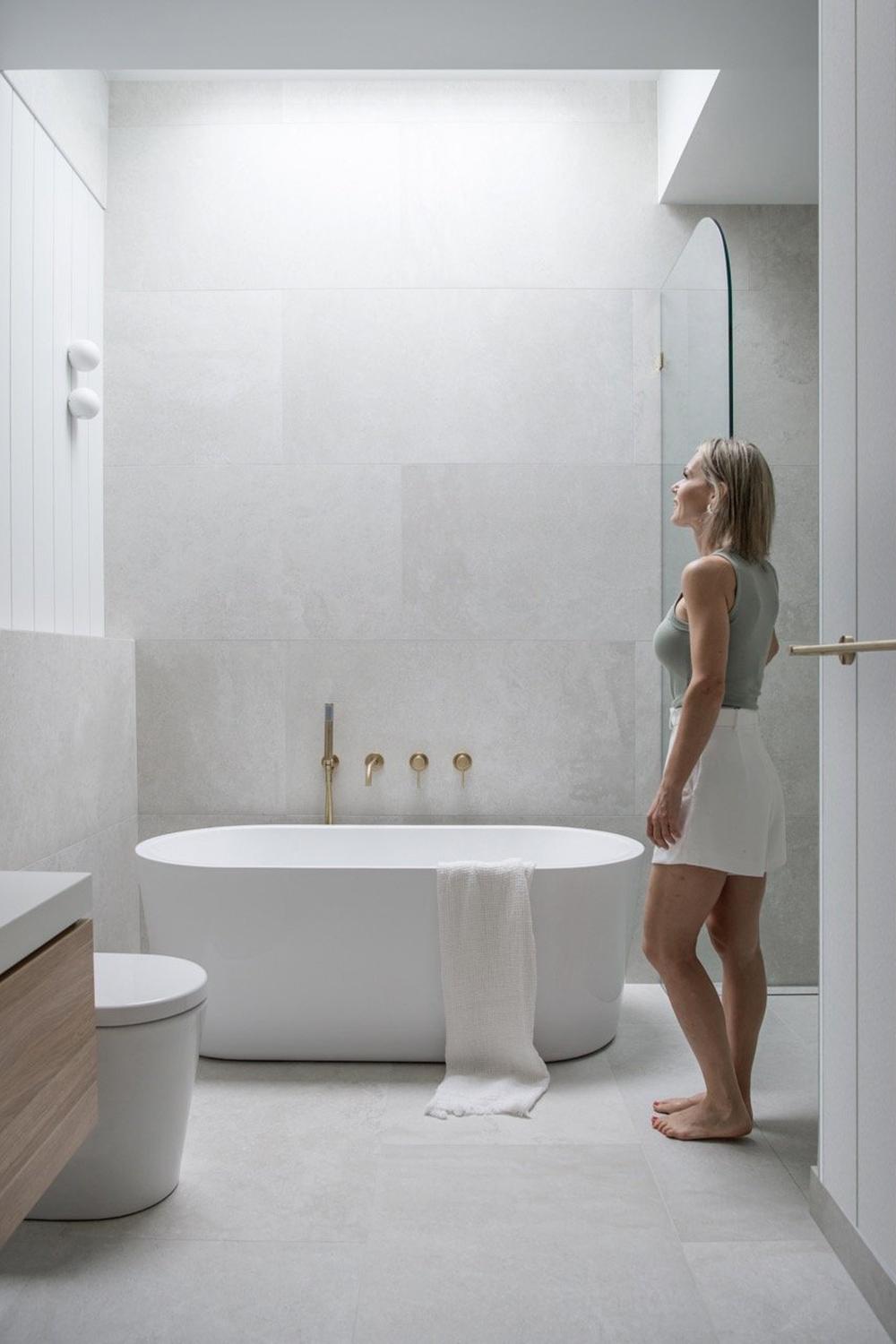 A charming bathroom with a vintage-style vanity and neutral tones, blending elegant elements for a rustic yet modern appeal.