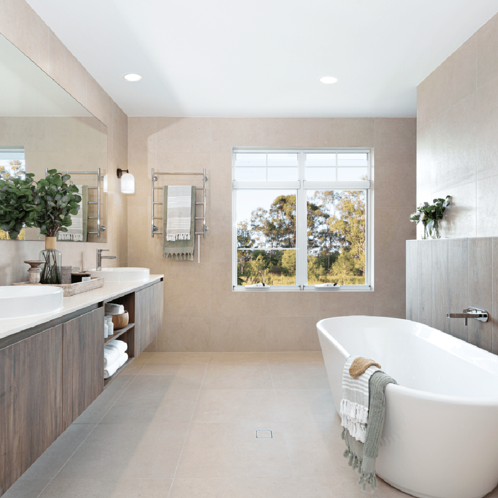 An upscale spa-like bathroom designed with soft tones, natural accessories, and a freestanding bathtub for an inviting atmosphere.