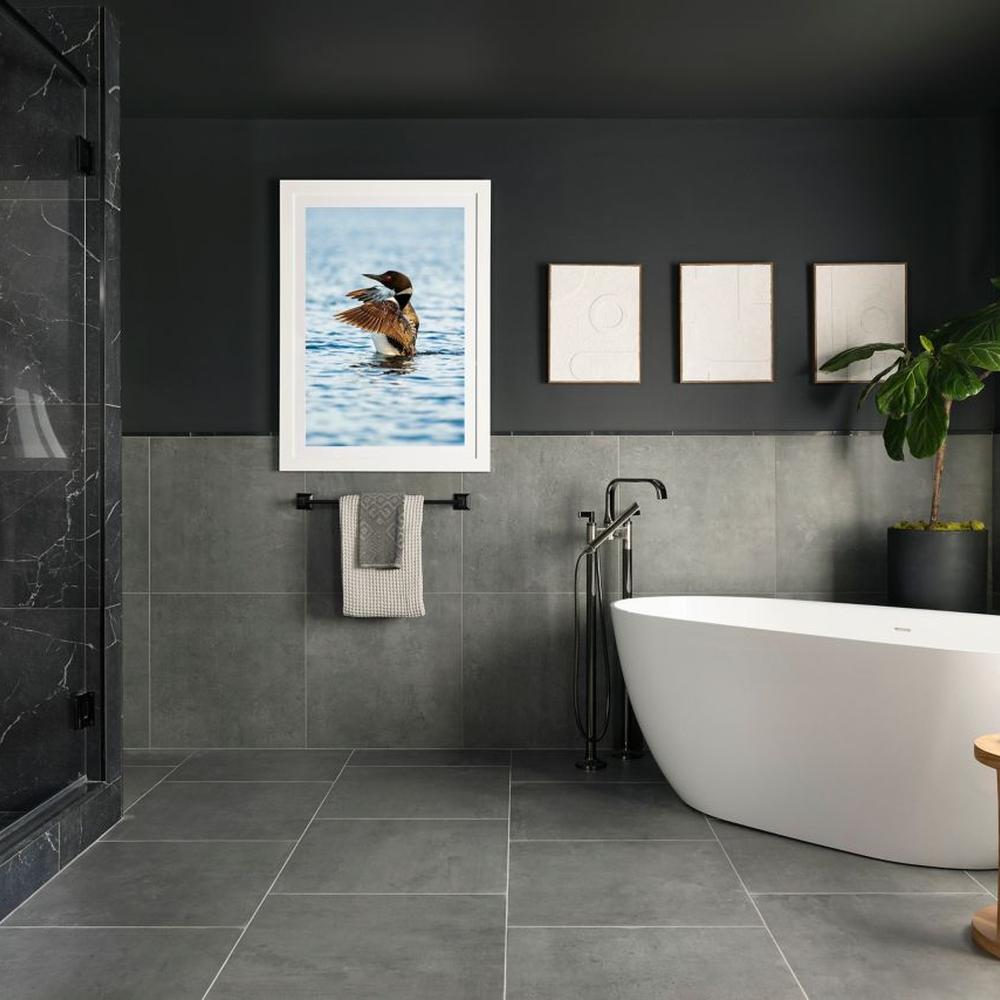 A bold bathroom showcasing contrasting designs with dark and light tones, creating a chic and modern atmosphere.