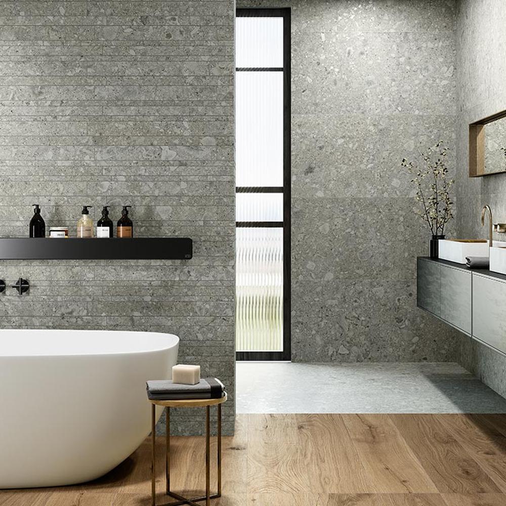 Bathroom with textured wall tiles and warm wood elements