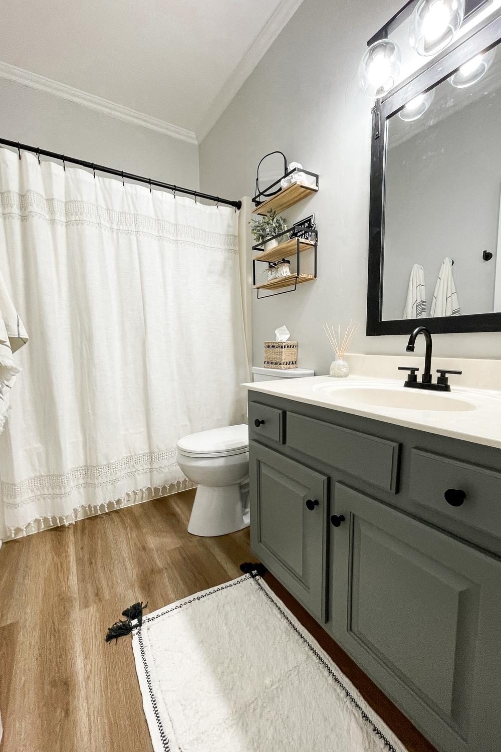 Dramatic black bathroom vanity showcasing rich design with a light marble top.