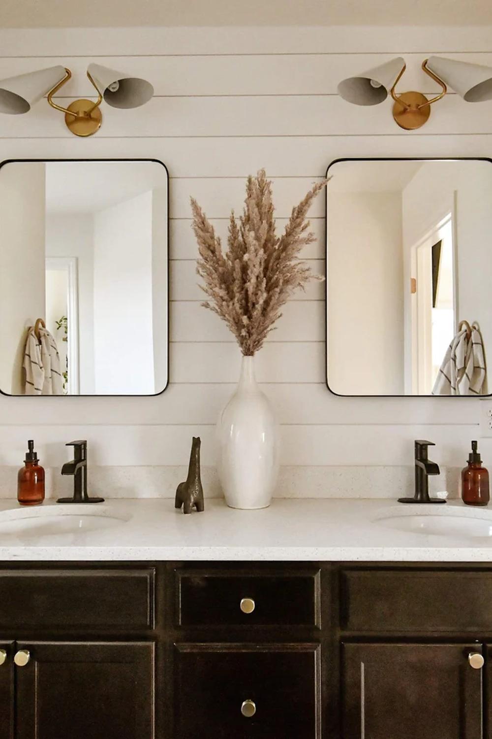 Stylish bathroom vanity with dark wood cabinetry and modern lighting
